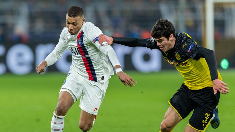 Kylian Mbappe of Paris Saint-Germain is challenged by Giovanni Reyna of Borussia Dortmund 