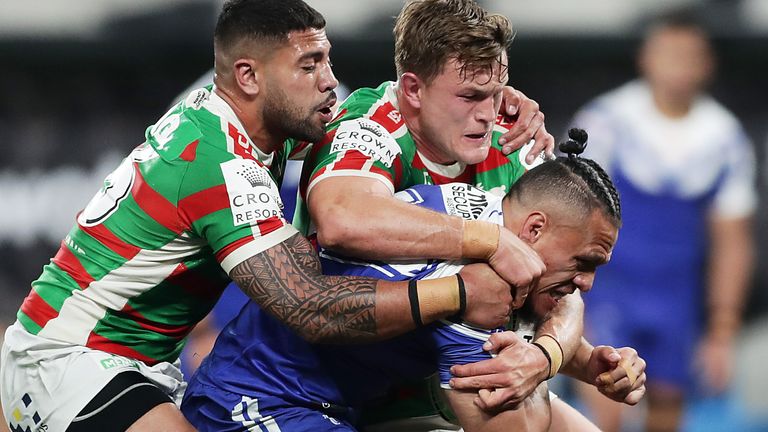 Sauaso Sue is wrapped up by the Rabbitohs defence
