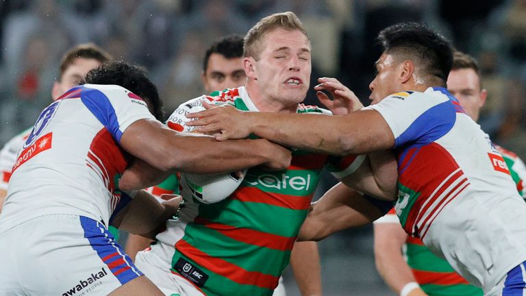 Tom Burgess is wrapped up by the Knights defence