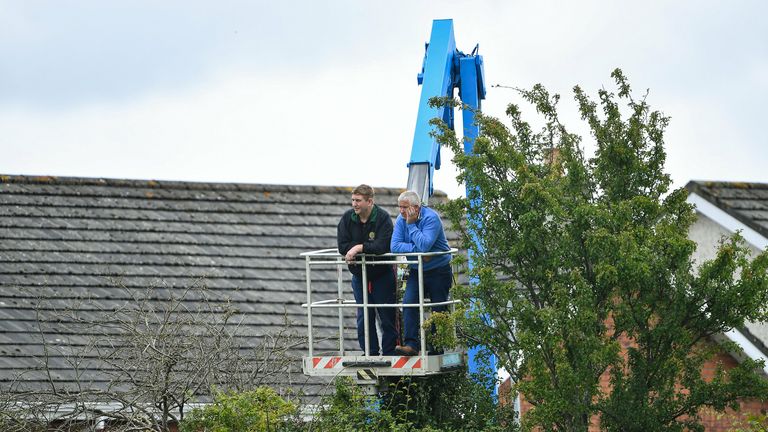 Toomevara supporters look on from a cherrypicker outside the ground in Nenagh