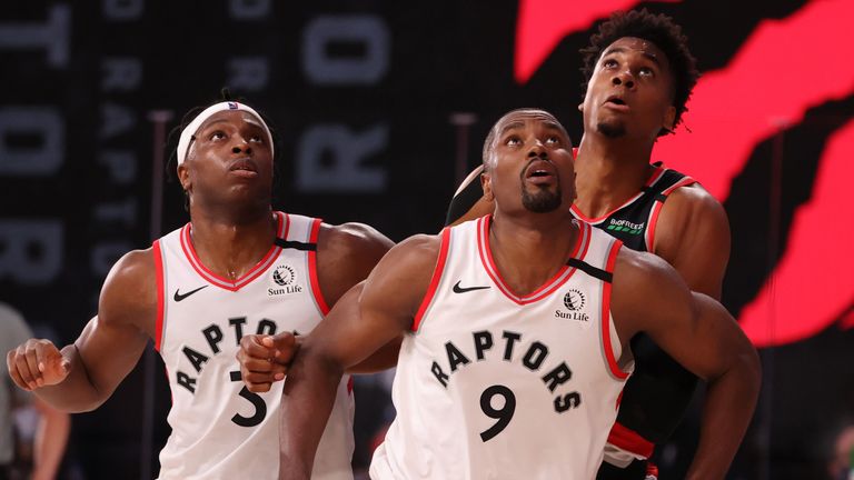 Serge Ibaka and Kyle Lowry contest a rebound with Hassan Whiteside