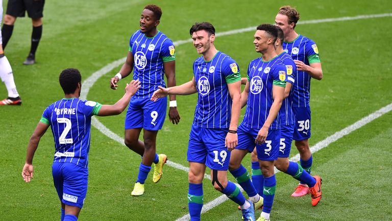 Kieffer Moore celebrates his second and Wigan's fifth after 40 minutes