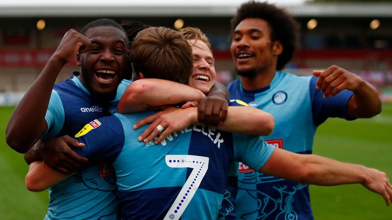 Wycombe players celebrate David Wheeler's goal which put them 3-1 up