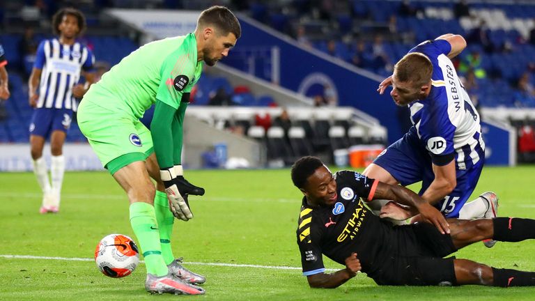 Raheem Sterling scores a header for Manchester City against Brighton while laying on the ground