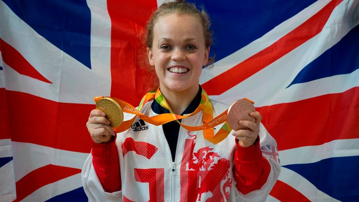 British paralympic gold and bronze medalist Ellie Simmonds poses with her medals after returning from the Rio 2016 Paralympic Games in Brazil, at Heathrow airport in London on September 20, 2016. 