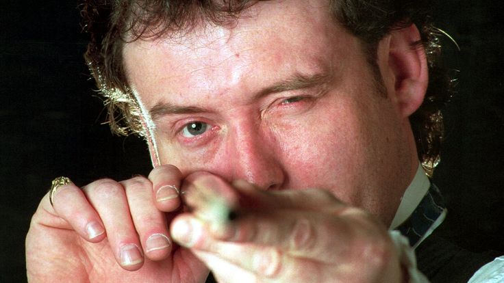 SNOOKER PLAYER JIMMY WHITE LOOKS STRAIGHT DOWN HIS CUE TO CHECK IT DURING A BREAK AT THE WORLD SNOOKER CHAMPIONSHIPS IN SHEFFIELD. 