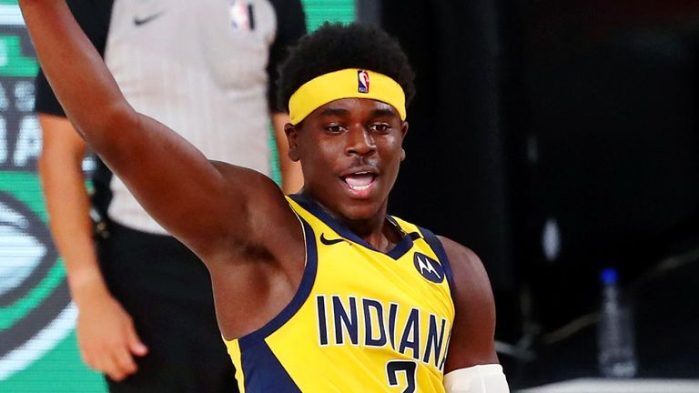 Aaron Holiday goes airborne to throw a pass during the Pacers' win over the Heat