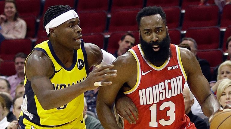 Aaron Holiday attempts to stop the driving James Harden