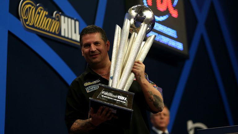 Gary Anderson lifts the world championship trophy after his 2015 win over Phil Taylor
