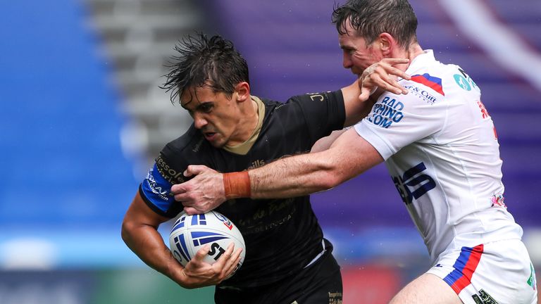 Catalans' Arthur Mourgue is tackled by Wakefield's Matty Ashurst.