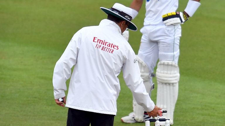 An umpire takes a light reading during day two of the Second Test match between England and Pakistan at the Ageas Bowl
