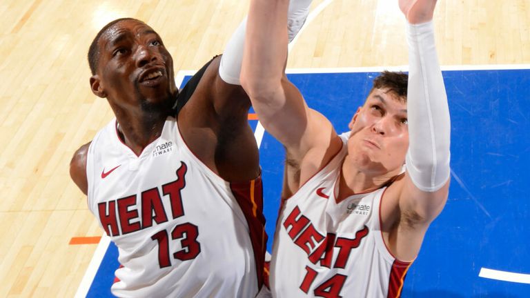 Miami Heat pair Bam Adebayo and Tyler Herro leap for a rebound