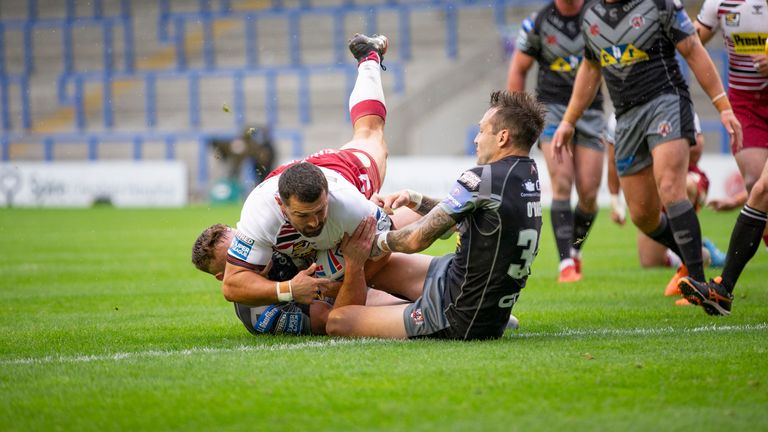 Ben Flower of Wigan scores a try.