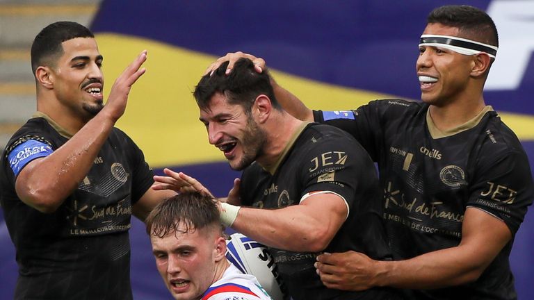 Picture by Alex Whitehead/SWpix.com - 22/08/2020 - Rugby League - Coral Challenge Cup - Catalans Dragons v Wakefield Trinity - John Smith's Stadium, Huddersfield, England - Catalans' Benjamin Garcia celebrates his try with Fouad Yaha and David Mead.