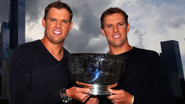 (L) Bob Bryan and (R) Mike Bryan of United States pose with the US Open men's doubles champions trophy in Central Park during their New York City media tour after winning their 100th career title on September 8, 2014 in New York City. 