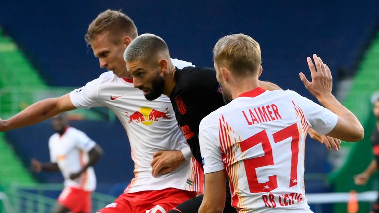 Atletico Madrid's Yannick Carrasco is challenged by Dani Olmo and Konrad Laimer of RB Leipzig