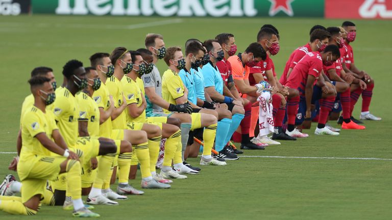 FRISCO, TX - AUGUST 12: FC Dallas Team (R) and Nashville SC Team get to their knees during the national anthem prior the game game between FC Dallas and Nashville SC as part of the Major League Soccer 2020 at Toyota Stadium on August 12, 2020 in Frisco, Texas. (Photo by Omar Vega/Getty Images)
