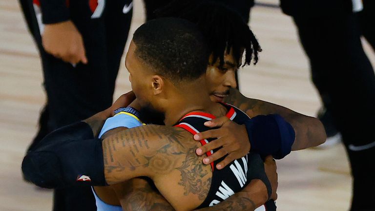 Damian Lillard hugs Ja Morant after Portland&#39;s victory over Memphis in the Western Conference Play-In