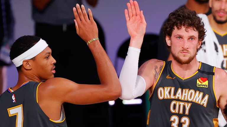 Darius Bazely and Mike Muscala high-five after the Thunder's win over the Heat