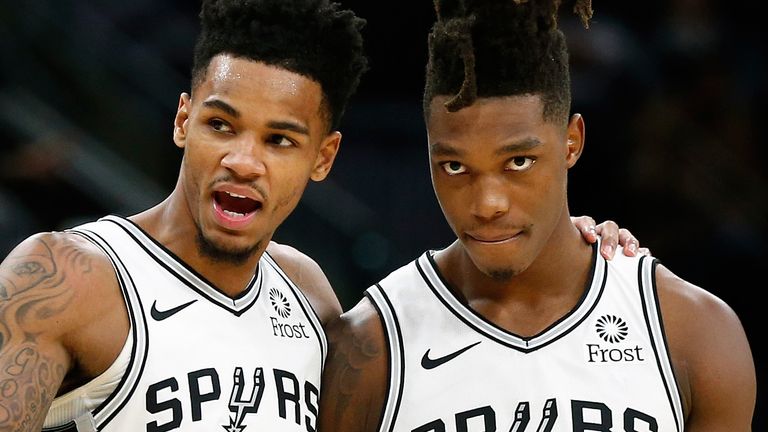 Dejounte Murray and Lonnie Walker share words during a Spurs game