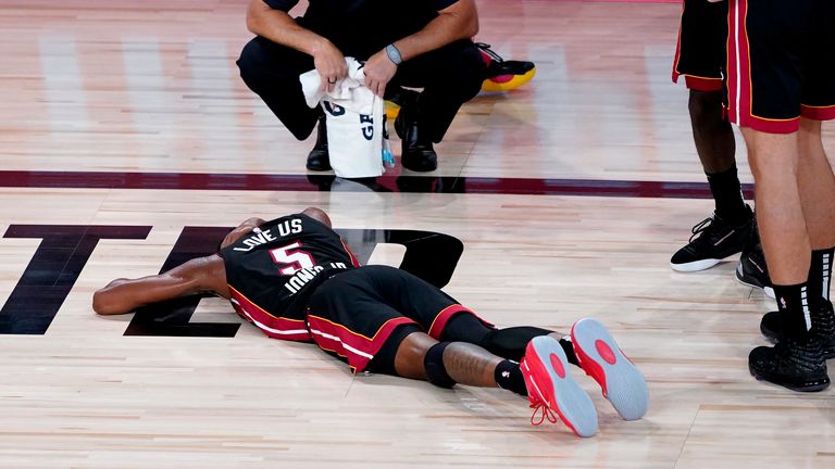 Miami Heat&#39;s Derrick Jones Jr. lies on the court after being injured against the Indiana Pacers