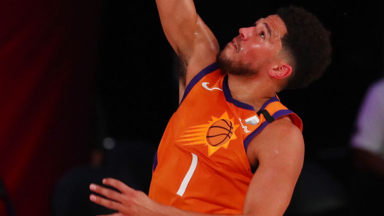 Devin Booker finishes at the rim in the Suns' win over the Wizards