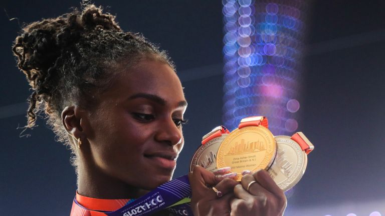 Britain's Dina Asher-Smith poses with her gold medal for the Women's 200m, silver medal for the Women's 100m and silver medal for the Women's 4x100m Relay during the medal ceremony at the 2019 IAAF Athletics World Championships at the Khalifa International stadium in Doha on October 6, 2019.