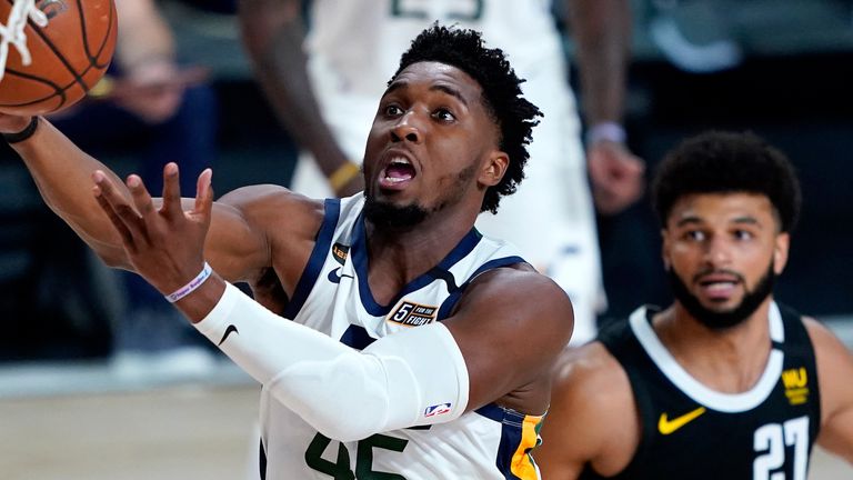 Donovan Mitchell finishes at the rim in Utah's Game 2 win against Denver