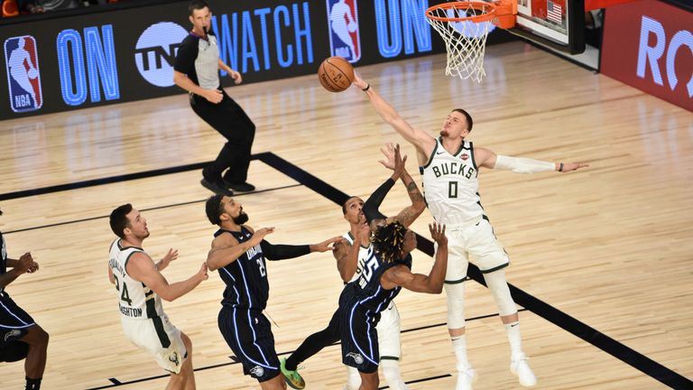 Donte DiVencenzo of the Bucks blocks a shot