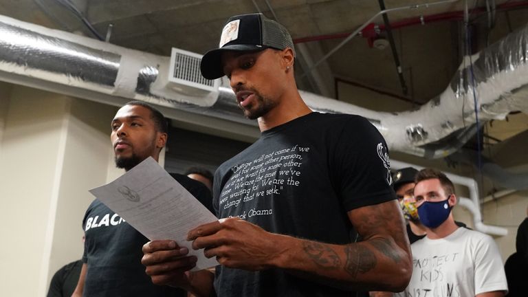 Milwaukee Bucks guard George Hill reads a statement following the players' decision to boycott their playoff game against the Orlando Magic