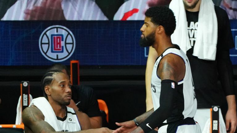 Kawhi Leonard #2 of the LA Clippers and Paul George #13 of the LA Clippers high-five during a game against the Dallas Mavericks during Round One, Game Five of the NBA Playoffs on August 25, 2020 at the AdventHealth Arena at ESPN Wide World Of Sports Complex in Orlando, Florida.