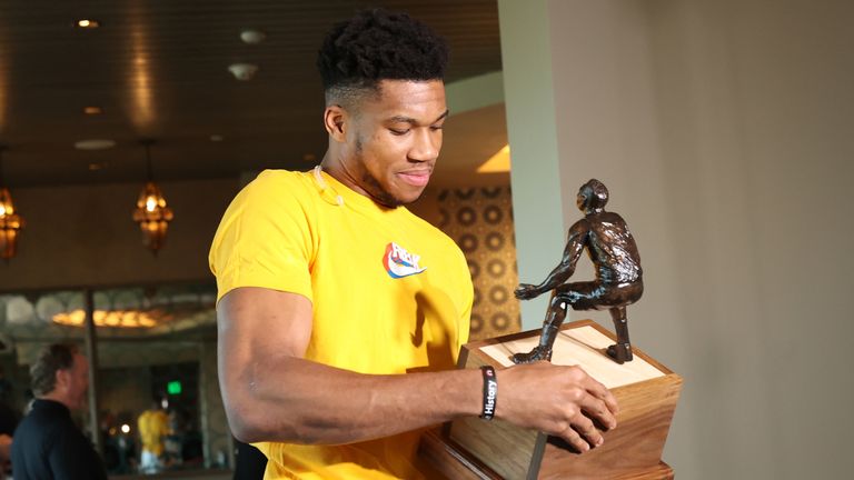 Giannis Antetokounmpo examines his trophy after being named the 2019-20 Defensive Player of the Year