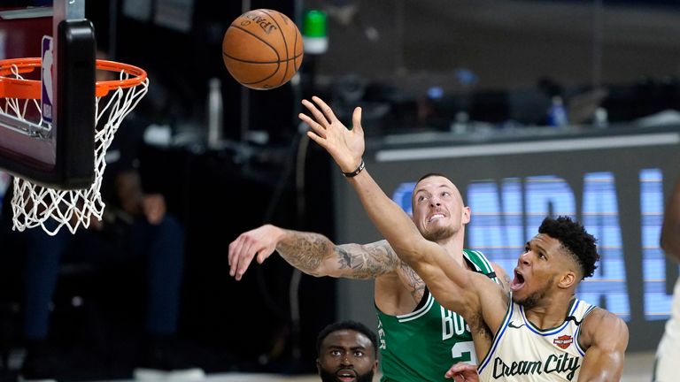 Milwaukee Bucks&#39; Giannis Antetokounmpo heads to the basket as Boston Celtics&#39; Daniel Theis defends