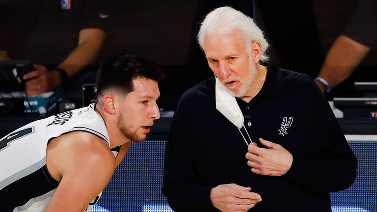 San Antonio Spurs coach Gregg Popovich speaks with Drew Eubanks