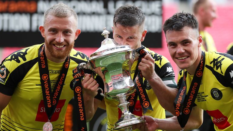 George Thomson, Josh Falkingham and Ryan Fallowfield celebrate Harrogate Town's promotion to the Football League.