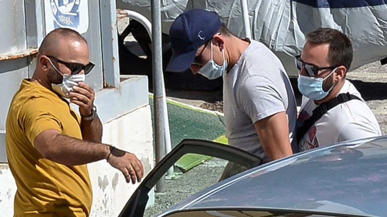 Harry Maguire, in the blue cap, at a police station on Syros (Pic: Athena Pictures)