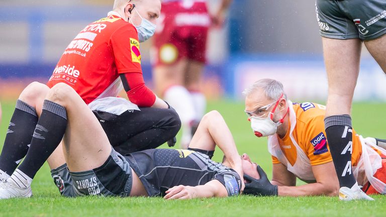 Castleford's James Clare lies injured before being stretchered from the field.