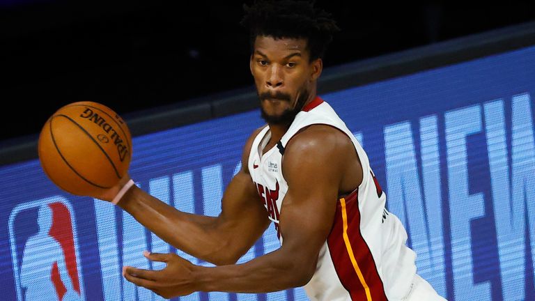 Jimmy Butler goes airborne to find a team-mate in the Heat's win over the Nuggets