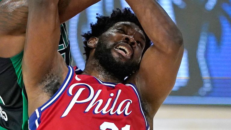 Joel Embiid defends the rim during the 76ers' Game 1 loss to the Celtics
