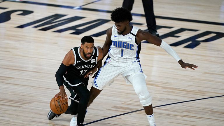 Brooklyn Nets' Garrett Temple (17) dribbles as Orlando Magic's Jonathan Isaac (1) defends 