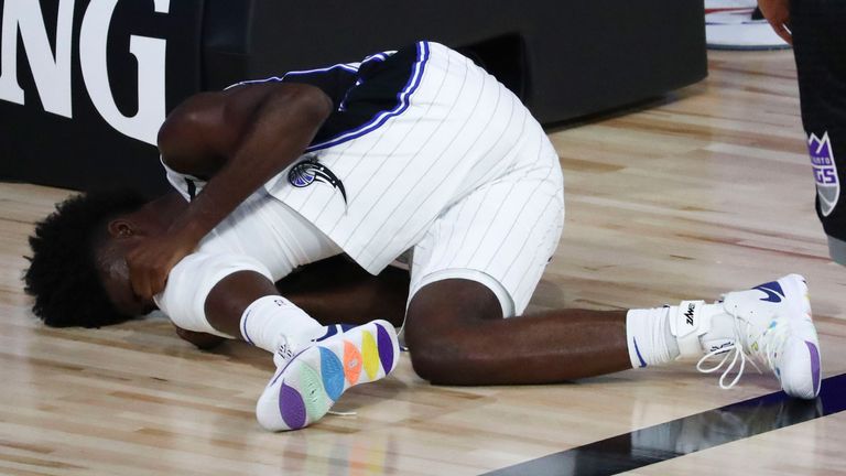 Jonathan Isaac suffers a knee injury during the Magic's win over the Kings