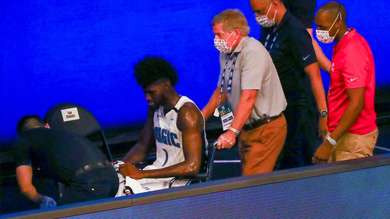 Jonathan Isaac is wheeled to the locker room after suffering a knee injury against the Kings