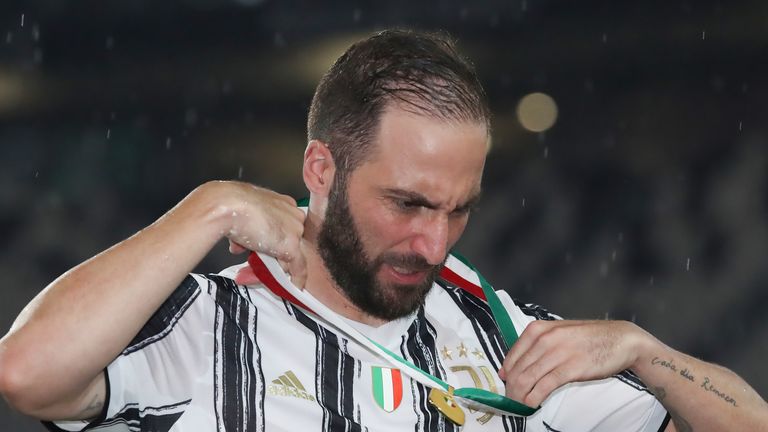 Gonzalo Higuain of Juventus removes his winners' medal as he leaves the field of play following the trophy presentation during the Serie A match at Allianz Stadium, Turin. Picture date: 1st August 2020. Picture credit should read: Jonathan Moscrop/Sportimage