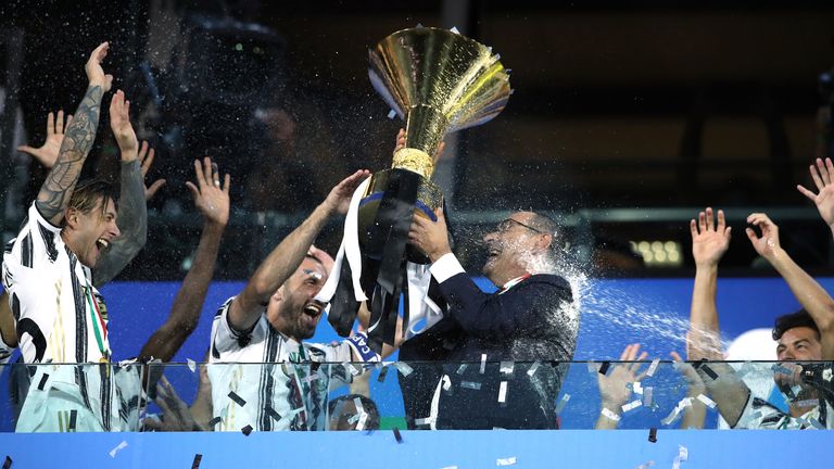 TURIN, ITALY - AUGUST 01: Maurizio Sarri Head coach of Juventus celebrates with the scudetto as he is sprayed with champagne by Wojciech Szczesny following the Serie A match between Juventus and AS Roma at on August 01, 2020 in Turin, Italy. (Photo by Jonathan Moscrop/Getty Images)
