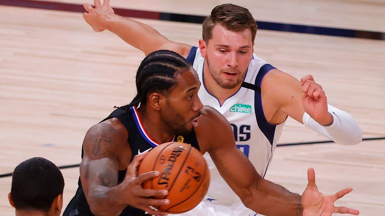 Kawhi Leonard of the LA Clippers drives against Luka Doncic of the Dallas Mavericks during  Game Six of the Western Conference First Round