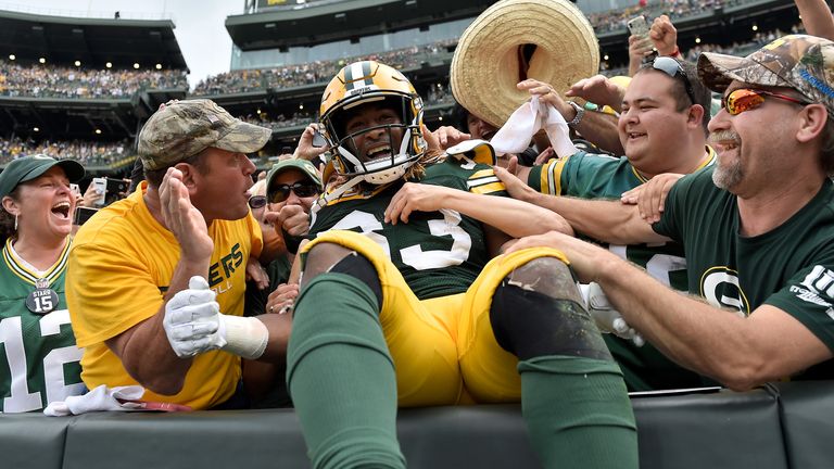 Aaron Jones celebrates with Packers fans in 2019