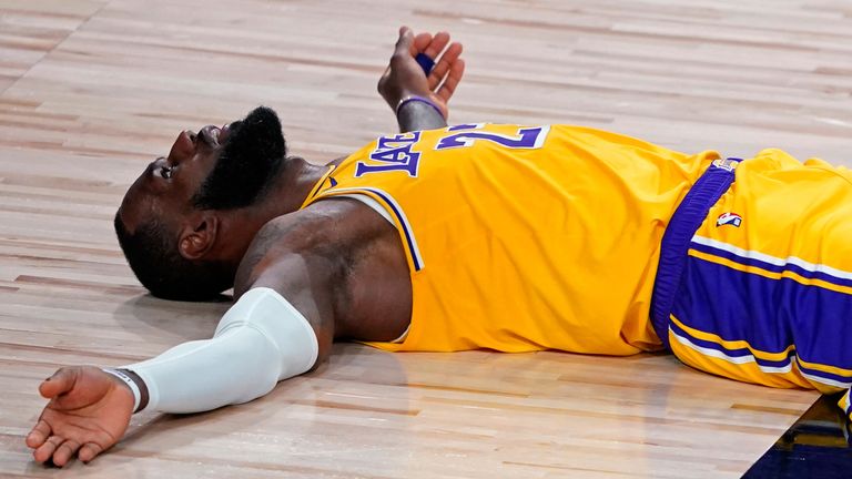 LeBron James lays on the court after being called for a foul during the Lakers&#39; Game 1 loss to the Trail Blazers