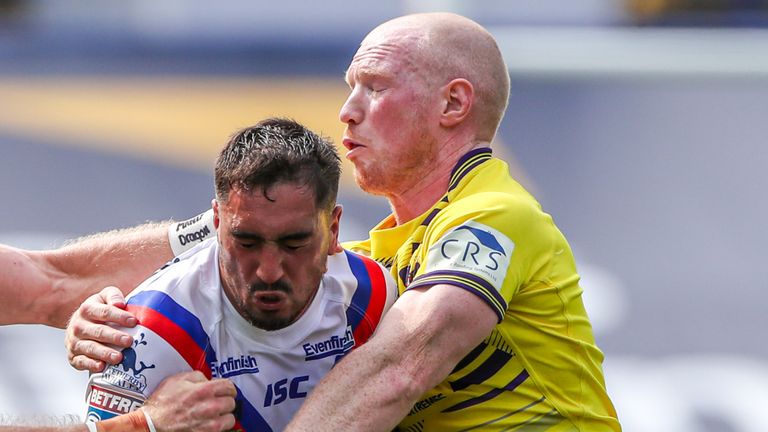 Picture by Alex Whitehead/SWpix.com - 09/08/2020 - Rugby League - Betfred Super League - Wakefield Trinity v Wigan Warriors - Emerald Headingley Stadium, Leeds, England - Wakefield's Tony Gigot is tackled by Wigan's Jackson Hastings and Liam Farrell.