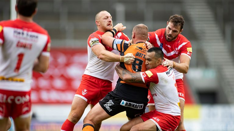  Liam Watts of Castleford is tackled by James Roby, Zeb Taia and Alex Walmsley of St Helens.