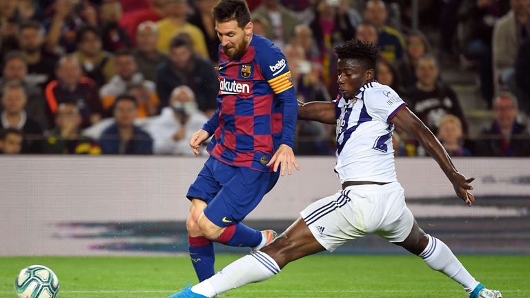 Salisu tackling Barcelona's Lionel Messi while playing for Valladolid